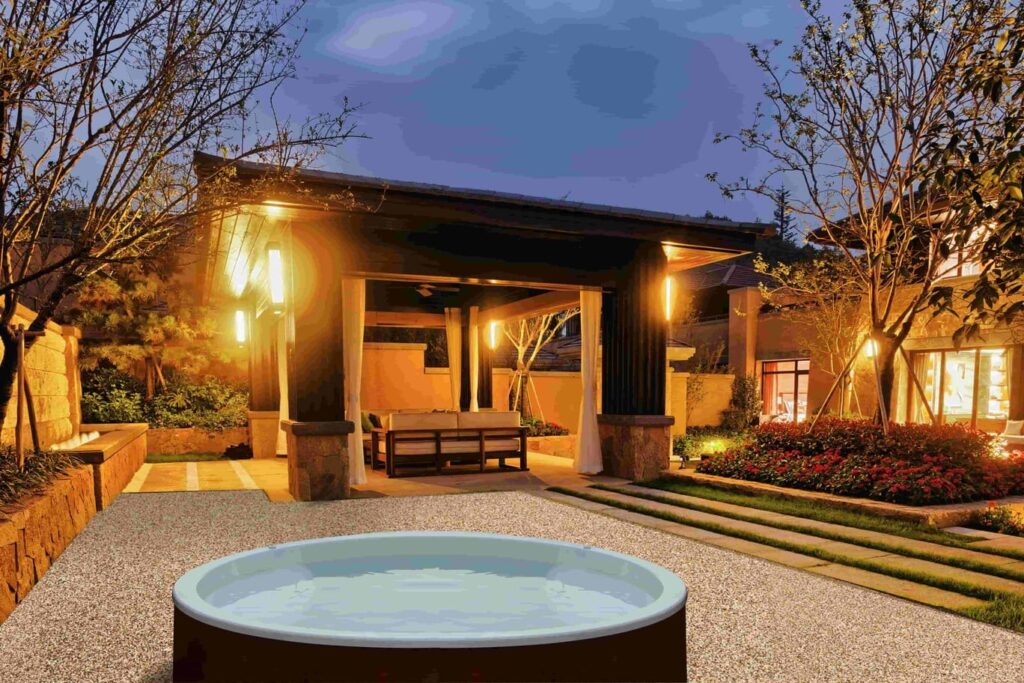 Spa pool lit up at night on a stable base