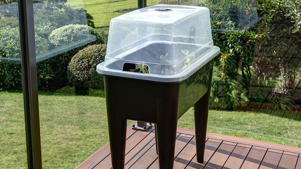 Raised garden bed with a protective lid